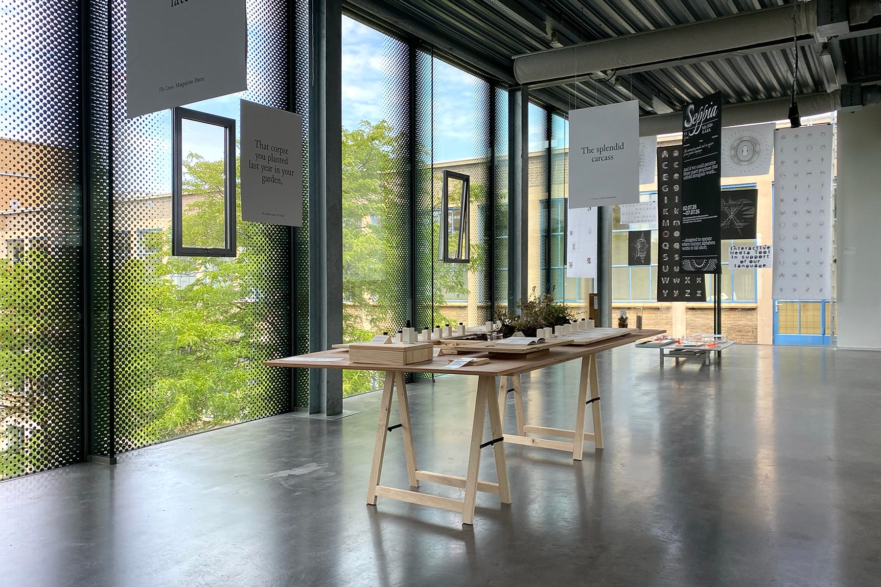 Assessment exhibition in the glass building with hanging prints