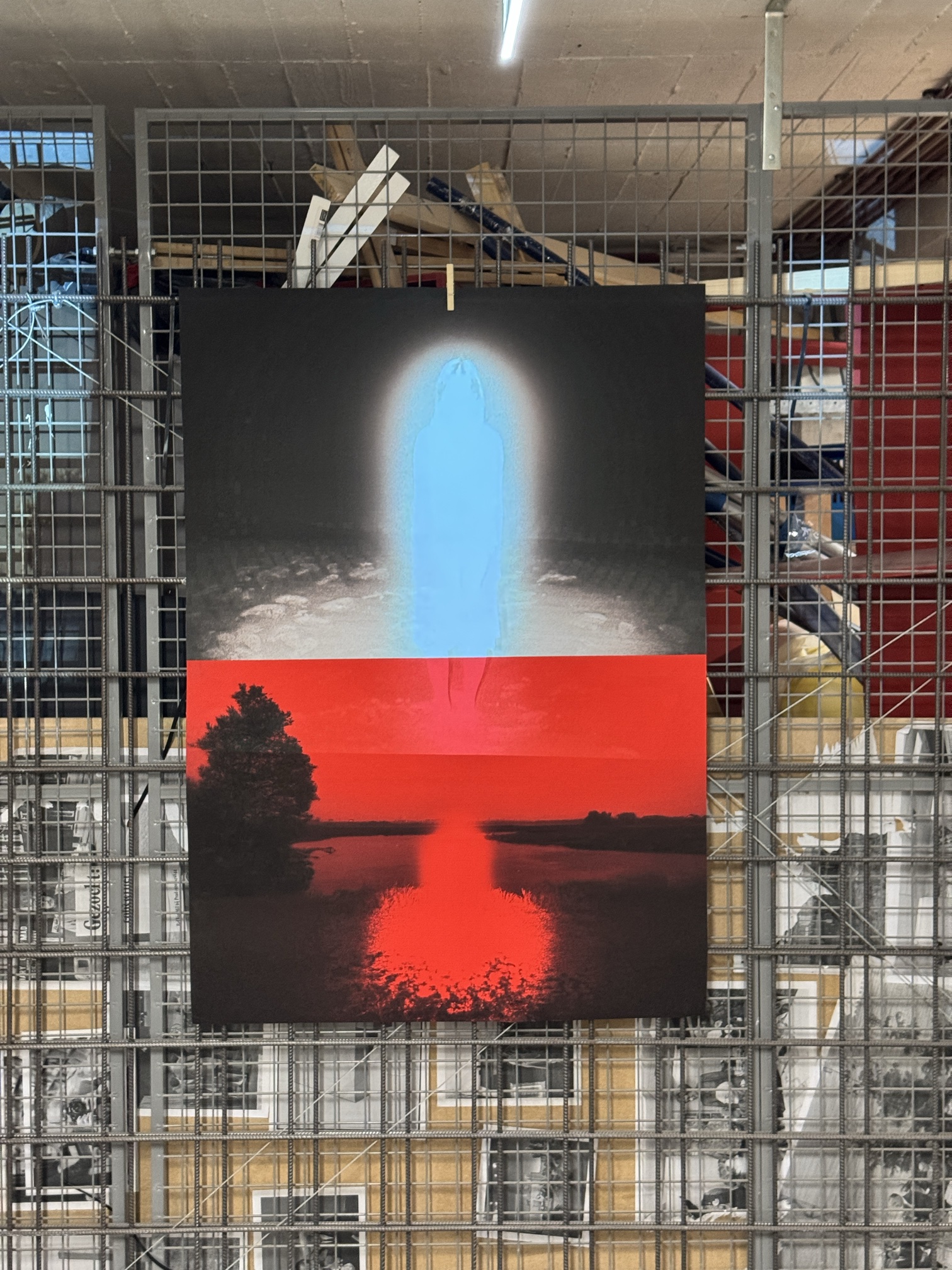 Close-up of the red and blue poster on the mesh wall