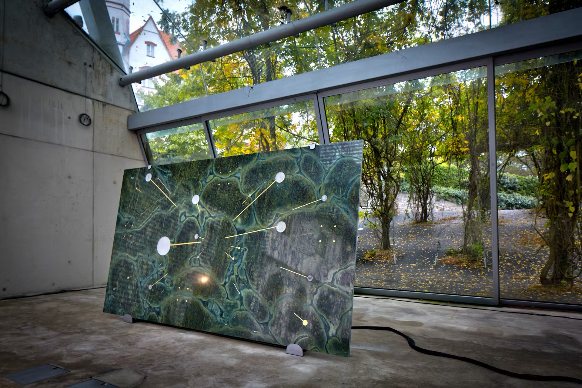 Illuminated stone panel installation in a glass pavilion